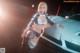 A woman in a bikini posing next to a car.
