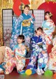 A group of women in kimonos posing for a picture.